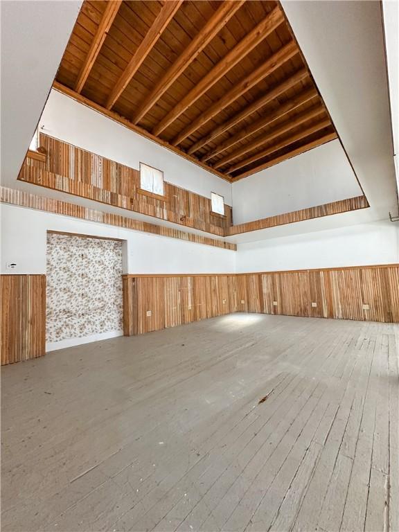 108 Public Sq, Berryville, AR 72616 - bonus room featuring a wooden ceiling with exposed beams, wooden walls, hardwood / wood-style floors, a wainscoted wall, and high vaulted ceiling
