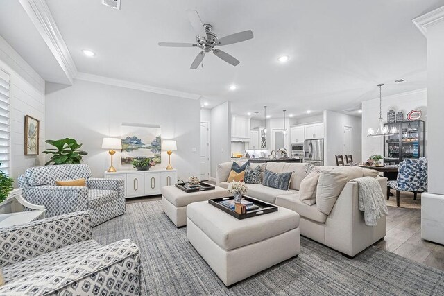9116 Kirkwood Rdg, Fort Smith, AR 72916 - living room featuring a ceiling fan, light wood finished floors, recessed lighting, ornamental molding, and a chandelier