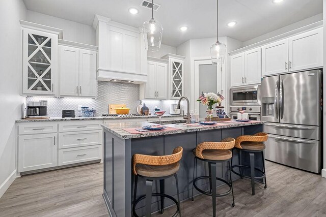 9116 Kirkwood Rdg, Fort Smith, AR 72916 - kitchen featuring appliances with stainless steel finishes, tasteful backsplash, white cabinetry, light wood-style floors, and recessed lighting