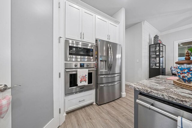 9116 Kirkwood Rdg, Fort Smith, AR 72916 - kitchen with appliances with stainless steel finishes, light wood-type flooring, white cabinetry, light stone countertops, and crown molding