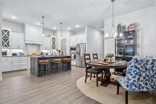 9116 Kirkwood Rdg, Fort Smith, AR 72916 - dining room featuring a chandelier, light wood-type flooring, and recessed lighting
