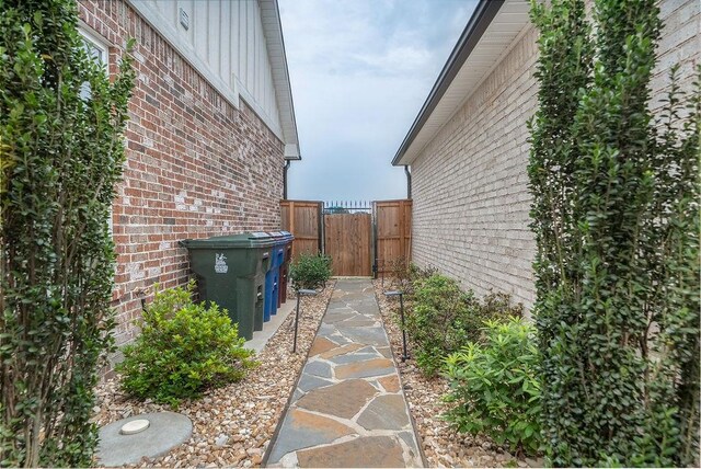 9116 Kirkwood Rdg, Fort Smith, AR 72916 - view of side of property featuring brick siding, a gate, and board and batten siding