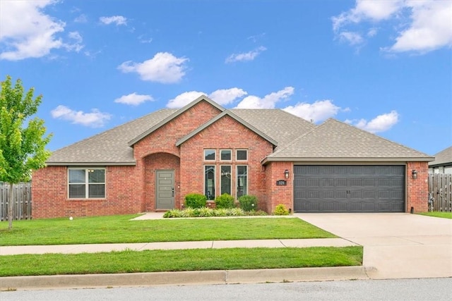 328 N Otoe St, Farmington, AR 72730 - view of front facade featuring brick siding, an attached garage, driveway, and roof with shingles
