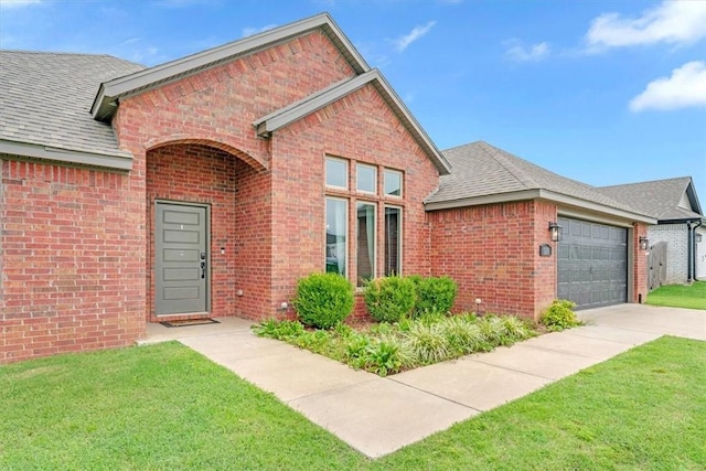 328 N Otoe St, Farmington, AR 72730 - view of front of home with an attached garage, brick siding, and roof with shingles