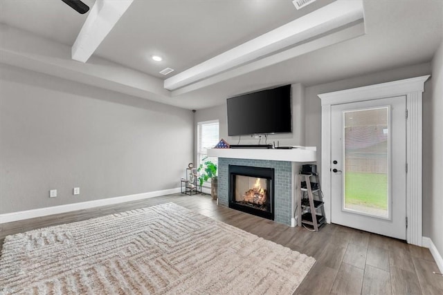328 N Otoe St, Farmington, AR 72730 - living room with wood finished floors, a tile fireplace, beamed ceiling, and recessed lighting