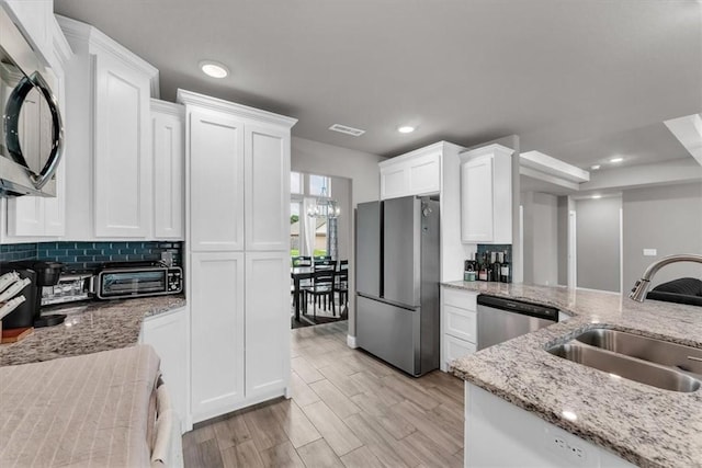 328 N Otoe St, Farmington, AR 72730 - kitchen featuring stainless steel appliances, white cabinetry, light wood-style floors, light stone counters, and recessed lighting