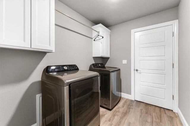 328 N Otoe St, Farmington, AR 72730 - washroom featuring washing machine and dryer, cabinet space, and light wood finished floors