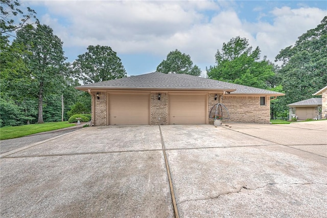 8553 Stoner Ln, Rogers, AR 72756 - view of side of home with brick siding, concrete driveway, a garage, and a shingled roof