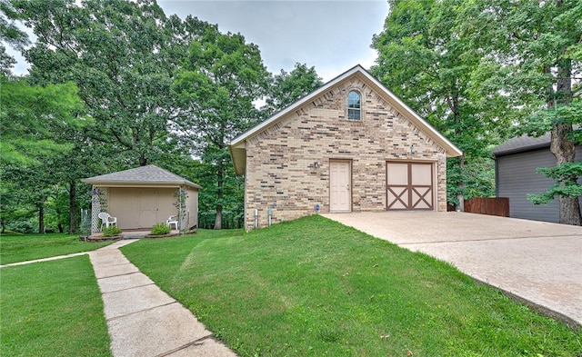 8553 Stoner Ln, Rogers, AR 72756 - view of front of home featuring brick siding, a garage, concrete driveway, a front lawn, and an outdoor structure