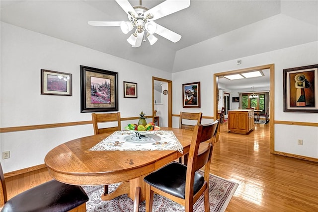 8553 Stoner Ln, Rogers, AR 72756 - dining space featuring light wood finished floors, a ceiling fan, and vaulted ceiling