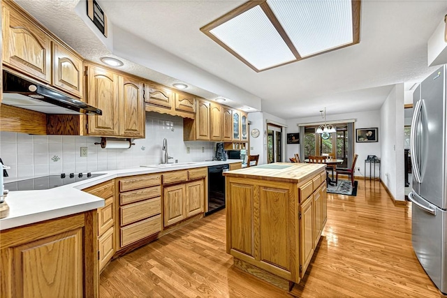 8553 Stoner Ln, Rogers, AR 72756 - kitchen with black appliances, under cabinet range hood, a center island, and light wood-type flooring