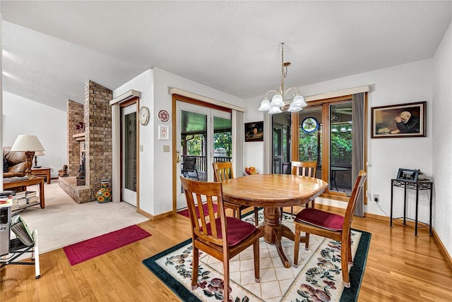 8553 Stoner Ln, Rogers, AR 72756 - dining room featuring a chandelier and light wood-type flooring