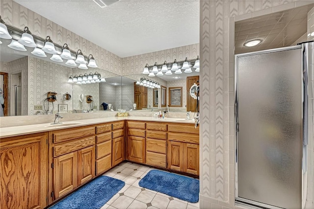 8553 Stoner Ln, Rogers, AR 72756 - bathroom featuring wallpapered walls, a shower stall, double vanity, tile patterned flooring, and a textured ceiling