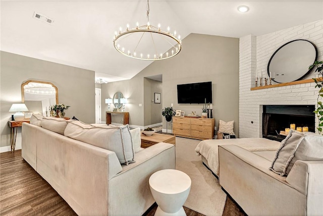 1314 N Fieldstone Ave, Fayetteville, AR 72704 - living room with vaulted ceiling, a chandelier, wood finished floors, and a fireplace