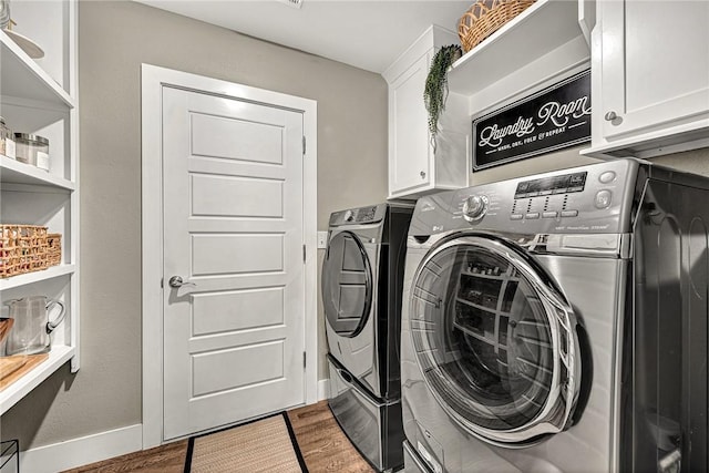 1314 N Fieldstone Ave, Fayetteville, AR 72704 - laundry room with cabinet space, washer and dryer, and wood finished floors