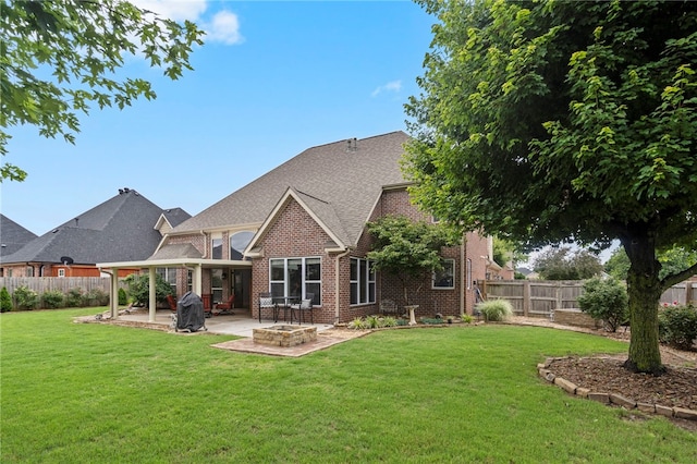 501 SE Fullerton St, Bentonville, AR 72712 - back of property with an outdoor fire pit, brick siding, a patio area, a fenced backyard, and a shingled roof