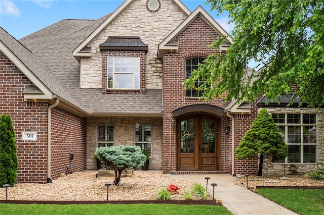 501 SE Fullerton St, Bentonville, AR 72712 - view of front of home featuring stone siding and roof with shingles