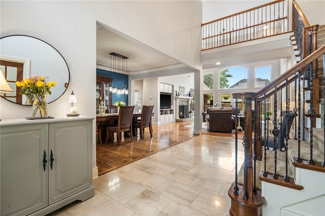 501 SE Fullerton St, Bentonville, AR 72712 - entrance foyer featuring a high ceiling, stairway, and a lit fireplace