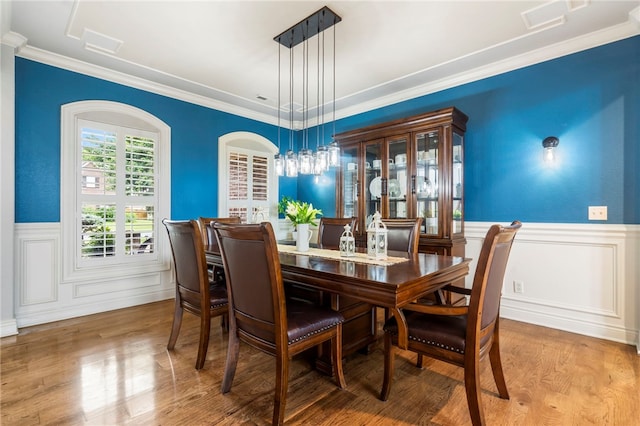 501 SE Fullerton St, Bentonville, AR 72712 - dining area featuring wood finished floors, a wainscoted wall, and ornamental molding