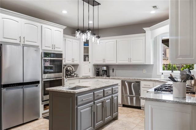 501 SE Fullerton St, Bentonville, AR 72712 - kitchen featuring stainless steel appliances, gray cabinetry, white cabinets, a center island, and recessed lighting