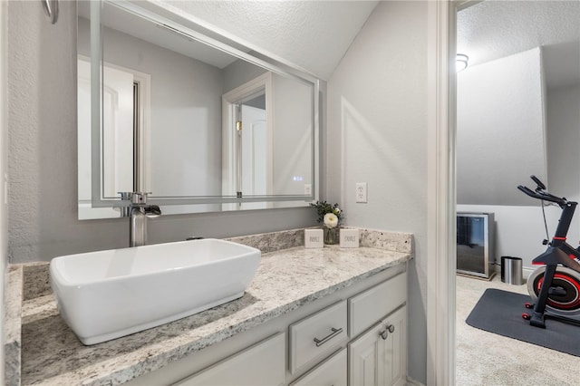 501 SE Fullerton St, Bentonville, AR 72712 - bathroom featuring vanity and vaulted ceiling