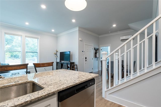 315 E 11th St, Fayetteville, AR 72701 - kitchen with stainless steel dishwasher, an AC wall unit, crown molding, light wood-style floors, and light stone countertops