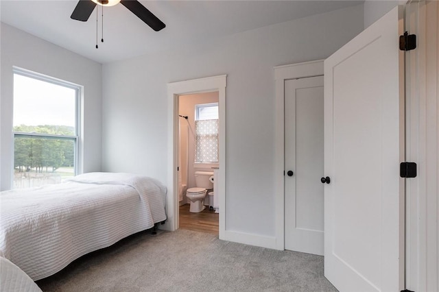 315 E 11th St, Fayetteville, AR 72701 - bedroom featuring multiple windows, light carpet, connected bathroom, and ceiling fan