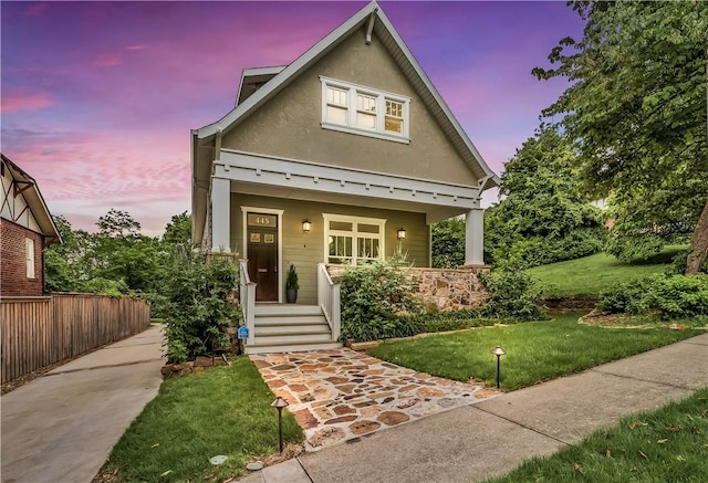 445 N Mock Ave, Fayetteville, AR 72701 - view of front of property featuring a porch, a front yard, and stucco siding
