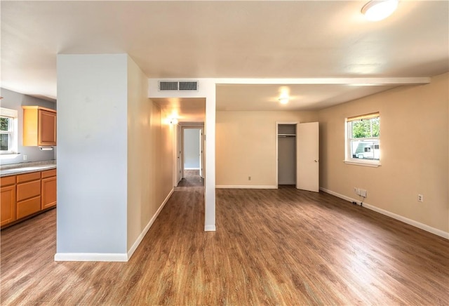 285 S 2nd St, Oaks, OK 74359 - unfurnished bedroom featuring wood finished floors, multiple windows, and a closet