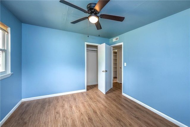 285 S 2nd St, Oaks, OK 74359 - unfurnished bedroom featuring wood finished floors, a closet, and a ceiling fan