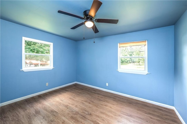 285 S 2nd St, Oaks, OK 74359 - empty room featuring healthy amount of natural light, wood finished floors, and a ceiling fan