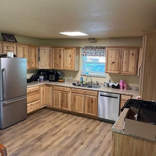 4841 Business Highway 412, Huntsville, AR 72740 - kitchen featuring stainless steel appliances, light brown cabinets, light wood-style floors, and a textured ceiling
