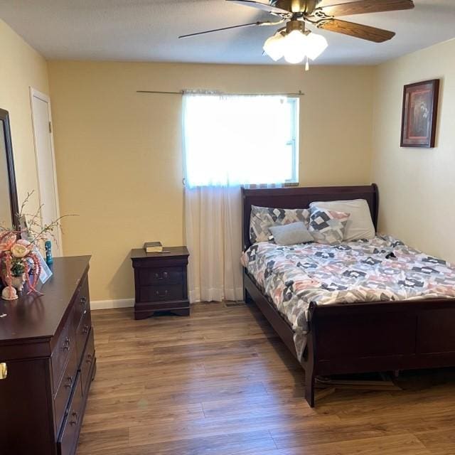 4841 Business Highway 412, Huntsville, AR 72740 - bedroom featuring wood finished floors and ceiling fan