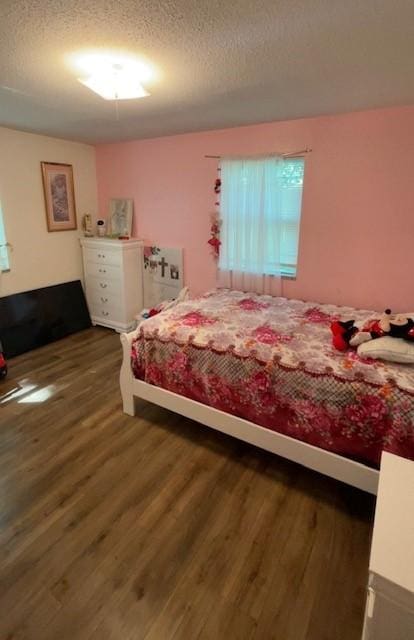 4841 Business Highway 412, Huntsville, AR 72740 - bedroom with wood finished floors and a textured ceiling