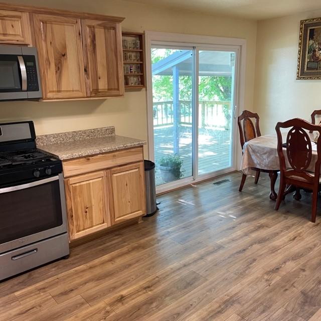 4841 Business Highway 412, Huntsville, AR 72740 - kitchen with appliances with stainless steel finishes, light countertops, light wood-style floors, and light brown cabinetry