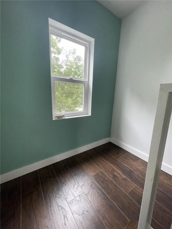 602 E Church Ave, Berryville, AR 72616 - spare room featuring dark wood-style floors and baseboards