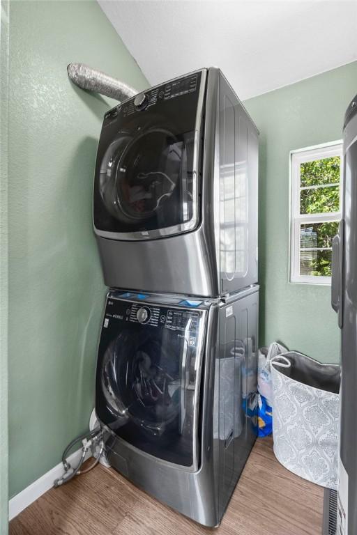 132 N Nature Trl Ln, Noel, MO 64854 - laundry area with stacked washer / drying machine and wood finished floors