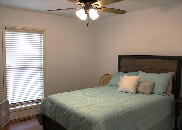 32 Table Rock Dr, Holiday Island, AR 72631 - bedroom with multiple windows, wood finished floors, and a ceiling fan