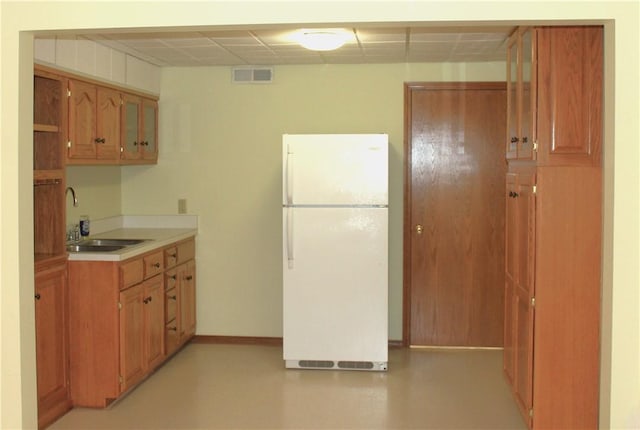 32 Table Rock Dr, Holiday Island, AR 72631 - kitchen featuring freestanding refrigerator, light countertops, and brown cabinetry
