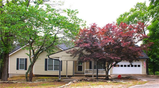 32 Table Rock Dr, Holiday Island, AR 72631 - obstructed view of property with a garage, a porch, and driveway