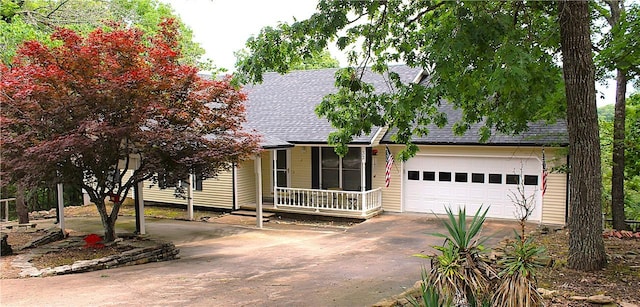 32 Table Rock Dr, Holiday Island, AR 72631 - view of front facade with concrete driveway, roof with shingles, and a garage