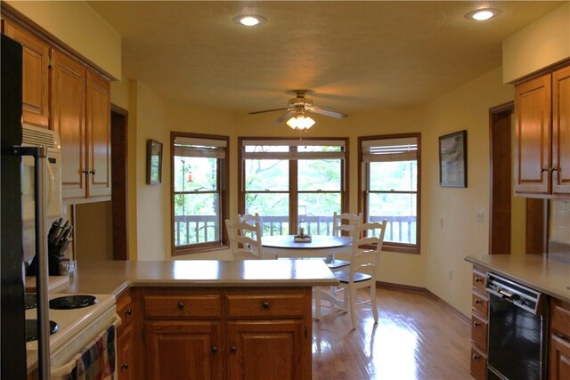 32 Table Rock Dr, Holiday Island, AR 72631 - kitchen with dishwasher, a peninsula, ceiling fan, light countertops, and brown cabinets