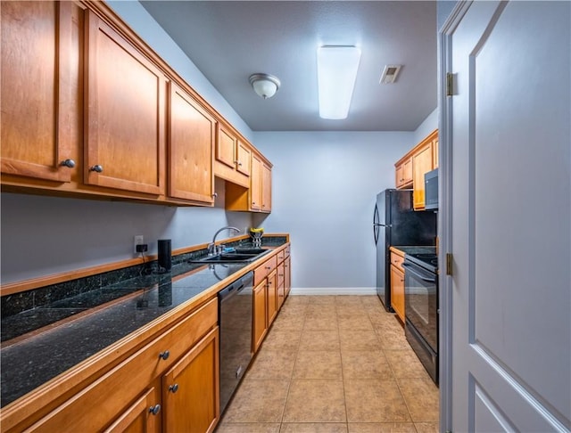 904 S Lafayette St, Rogers, AR 72758 - kitchen with black appliances, light tile patterned flooring, and brown cabinetry