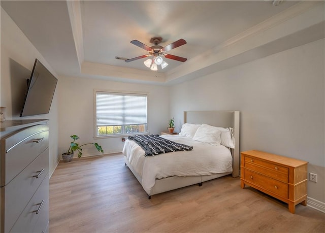 904 S Lafayette St, Rogers, AR 72758 - bedroom with a tray ceiling, light wood-style flooring, and a ceiling fan