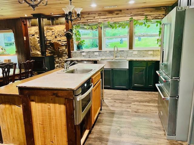 14163 Low Gap Wc 100 Rd, West Fork, AR 72774 - kitchen featuring high quality fridge, green cabinets, light wood-style floors, light countertops, and a chandelier