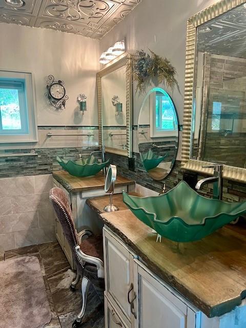 14163 Low Gap Wc 100 Rd, West Fork, AR 72774 - bathroom with an ornate ceiling, vanity, healthy amount of natural light, tile walls, and wainscoting