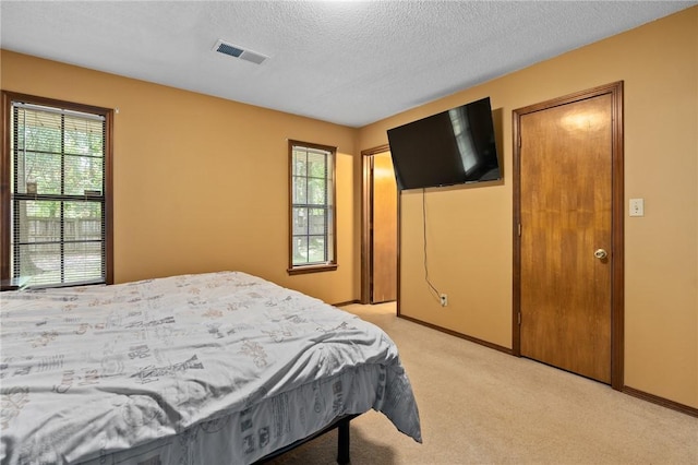 319 Belle Ave, Alma, AR 72921 - bedroom featuring light carpet and a textured ceiling