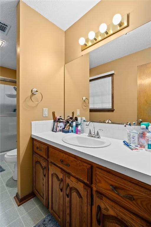 319 Belle Ave, Alma, AR 72921 - bathroom with tile patterned floors, vanity, and a shower
