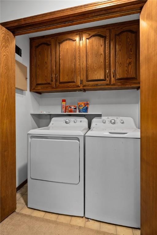 319 Belle Ave, Alma, AR 72921 - washroom featuring washing machine and clothes dryer, cabinet space, and light tile patterned flooring