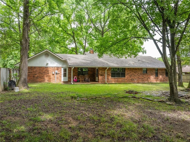 319 Belle Ave, Alma, AR 72921 - rear view of house with a chimney, brick siding, and a patio area